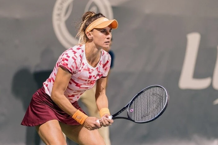 Ukrainian tennis player holds documents in her hands
